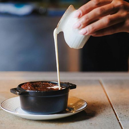 Stock Exchange Hotel, Manchester, Autograph Collection Екстериор снимка A pot of chocolate pudding being topped with cream