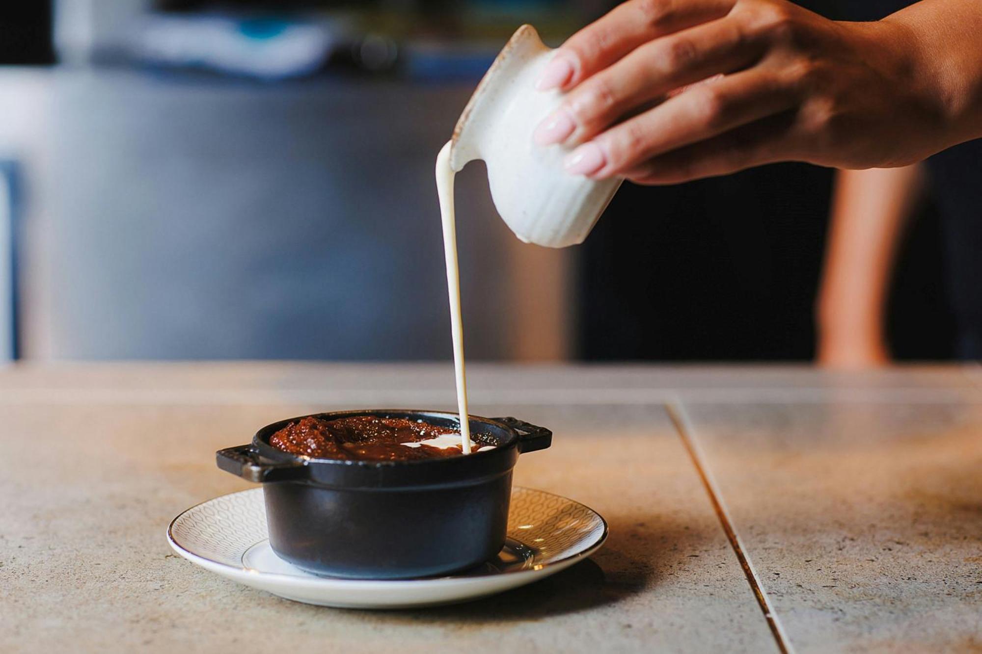 Stock Exchange Hotel, Manchester, Autograph Collection Екстериор снимка A pot of chocolate pudding being topped with cream